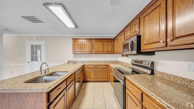 kitchen featuring stainless steel appliances, light tile patterned flooring, a textured ceiling, ornamental molding, and sink