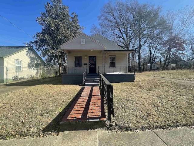 bungalow-style home with a front yard and covered porch