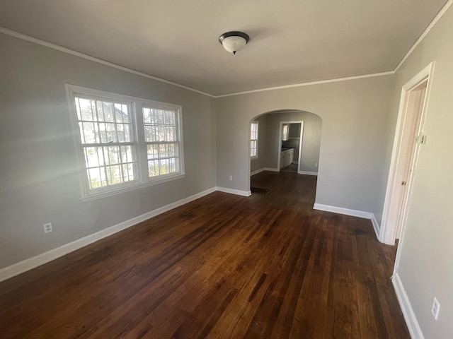 spare room with dark hardwood / wood-style floors and ornamental molding