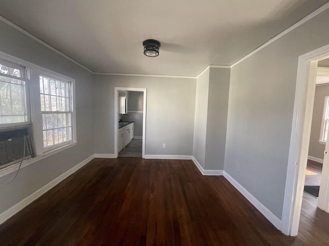 interior space with dark hardwood / wood-style floors, crown molding, and connected bathroom