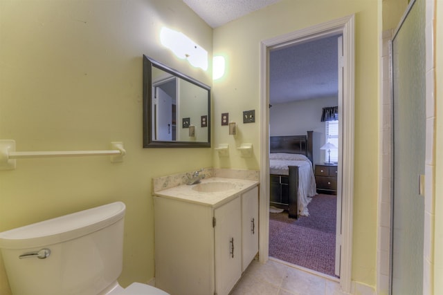 bathroom featuring a textured ceiling, toilet, tile patterned flooring, and vanity