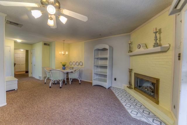 home office featuring ceiling fan with notable chandelier, a textured ceiling, light carpet, a brick fireplace, and crown molding