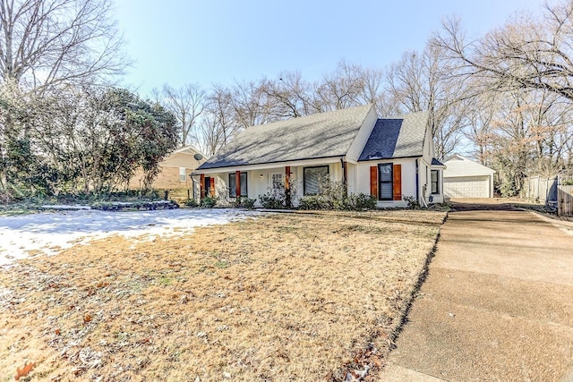 view of front of house featuring a front yard, covered porch, and a garage