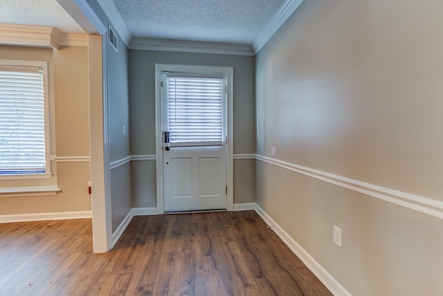 entryway featuring a textured ceiling, ornamental molding, and dark hardwood / wood-style floors