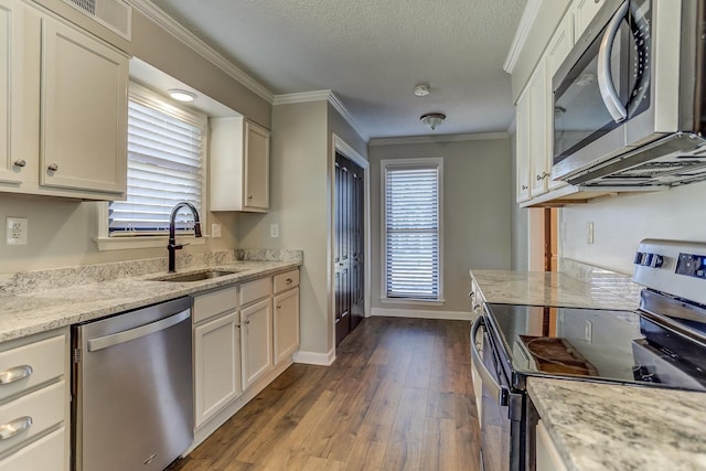 kitchen with sink, white cabinetry, stainless steel appliances, dark hardwood / wood-style flooring, and light stone counters