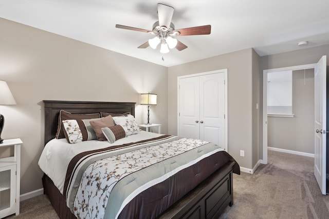 carpeted bedroom featuring ceiling fan and a closet