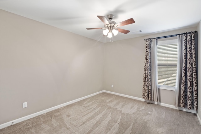 carpeted empty room featuring ceiling fan