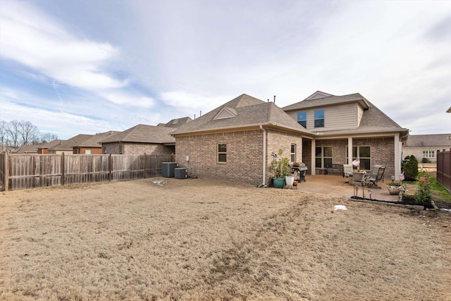 rear view of house with a patio area and cooling unit