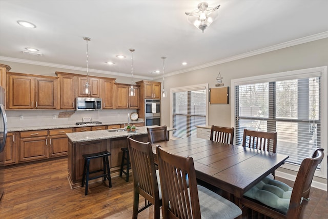 dining space featuring dark hardwood / wood-style flooring and ornamental molding