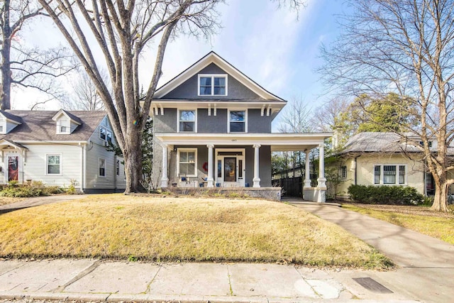 view of front facade with a front yard and a porch