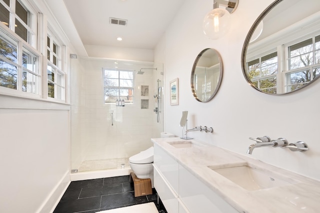 bathroom with toilet, tile patterned flooring, a shower with shower door, and vanity