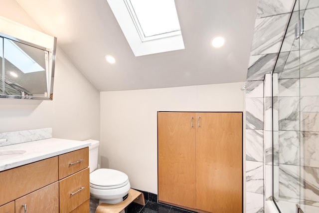 bathroom featuring toilet, vanity, a skylight, and a shower with door