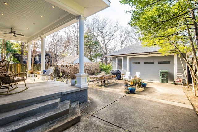 view of patio / terrace featuring ceiling fan, a grill, a garage, and an outdoor structure