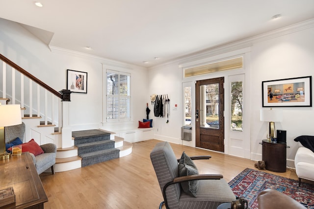 living room featuring crown molding and light hardwood / wood-style flooring