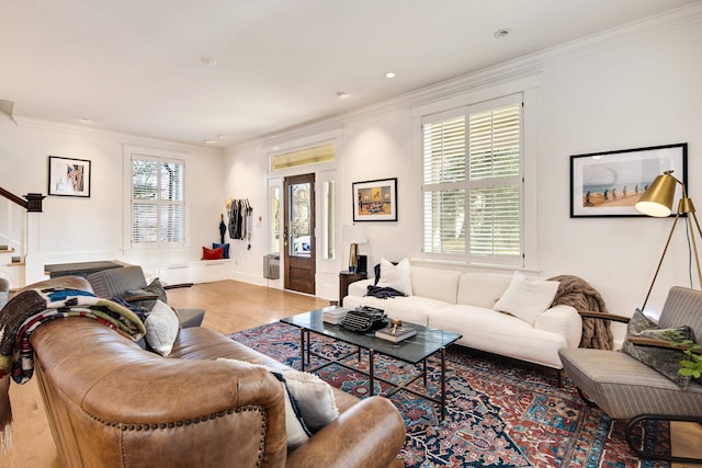 living room featuring crown molding, a healthy amount of sunlight, and hardwood / wood-style flooring