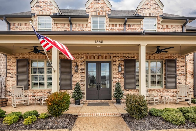 property entrance featuring a balcony, french doors, and ceiling fan