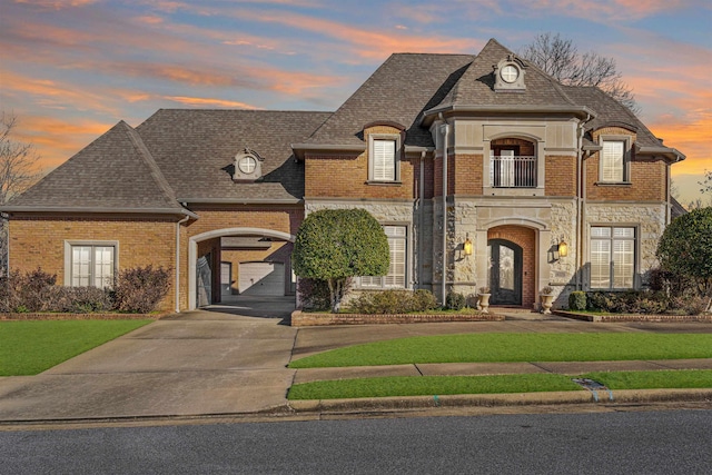 french country inspired facade with a lawn