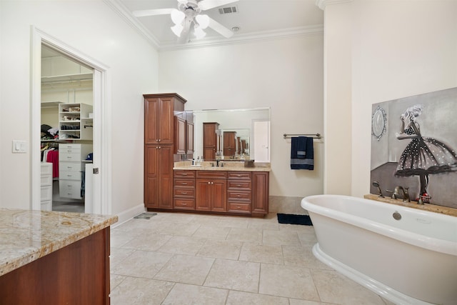 bathroom with ceiling fan, vanity, crown molding, and a bath