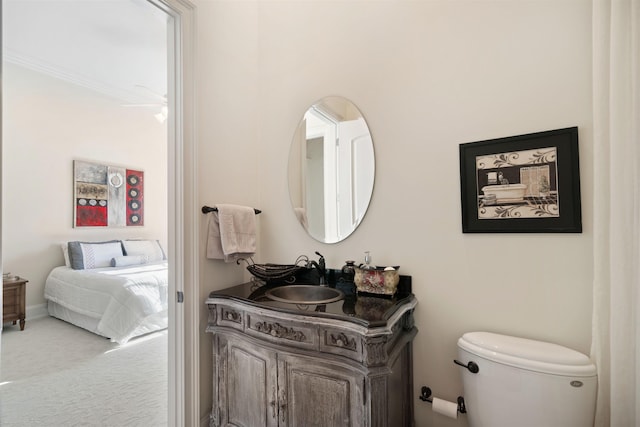 bathroom featuring toilet and vanity