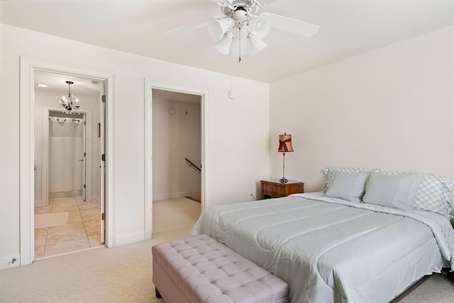 bedroom with light colored carpet and ceiling fan with notable chandelier