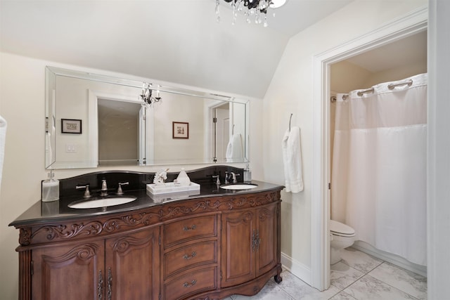 bathroom featuring toilet, vanity, lofted ceiling, and an inviting chandelier