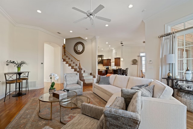 living room with ceiling fan, crown molding, and hardwood / wood-style flooring