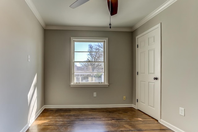 spare room with ornamental molding, dark wood-type flooring, and ceiling fan