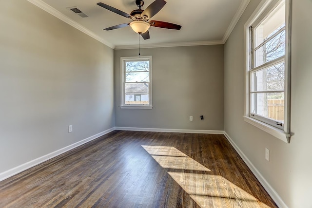 spare room featuring crown molding, dark wood-type flooring, and ceiling fan