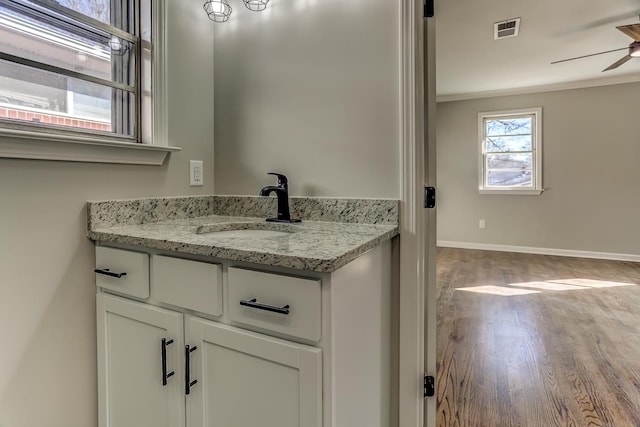 bathroom featuring vanity, crown molding, plenty of natural light, and ceiling fan