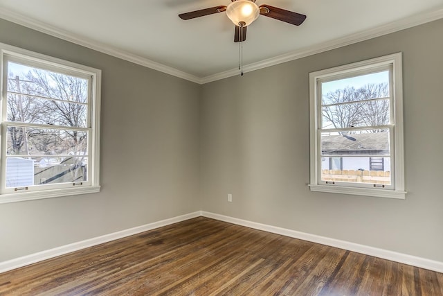 spare room featuring ceiling fan, ornamental molding, a healthy amount of sunlight, and dark hardwood / wood-style flooring