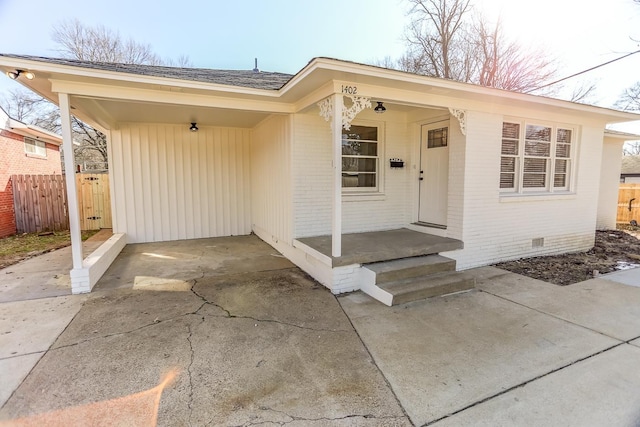 view of exterior entry with a carport