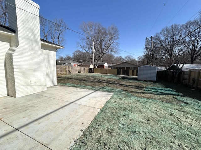 view of yard with a storage shed and a patio area