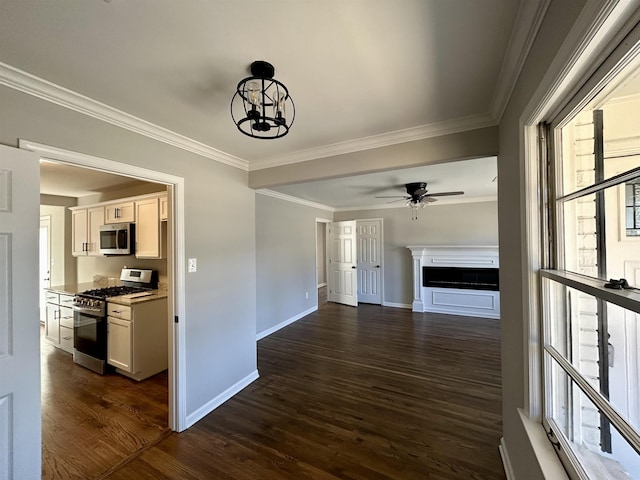 interior space featuring ceiling fan with notable chandelier, ornamental molding, and dark hardwood / wood-style floors