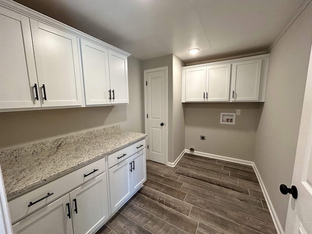 clothes washing area with washer hookup, dark hardwood / wood-style floors, cabinets, and hookup for an electric dryer