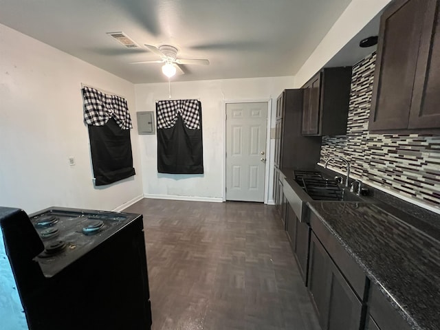 kitchen featuring ceiling fan, backsplash, sink, dark brown cabinetry, and dark parquet floors