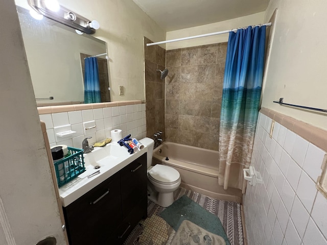 full bathroom featuring toilet, vanity, tile walls, and shower / bath combo with shower curtain