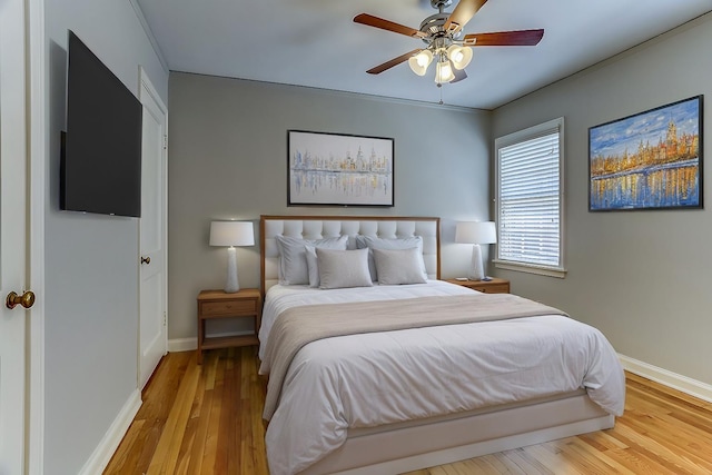 bedroom with ceiling fan and light hardwood / wood-style flooring