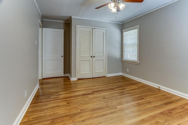 unfurnished bedroom with ceiling fan, a closet, light wood-type flooring, and ornamental molding