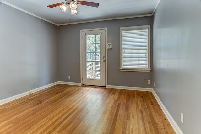 doorway to outside with ceiling fan, light wood-type flooring, and crown molding