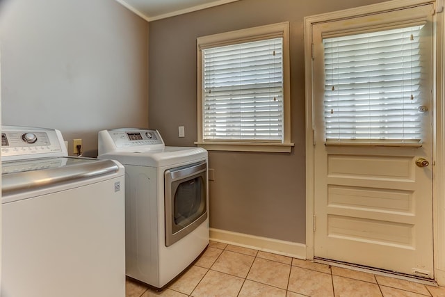 washroom with separate washer and dryer and light tile patterned flooring