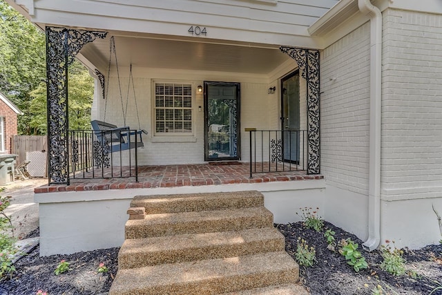 view of exterior entry featuring a porch