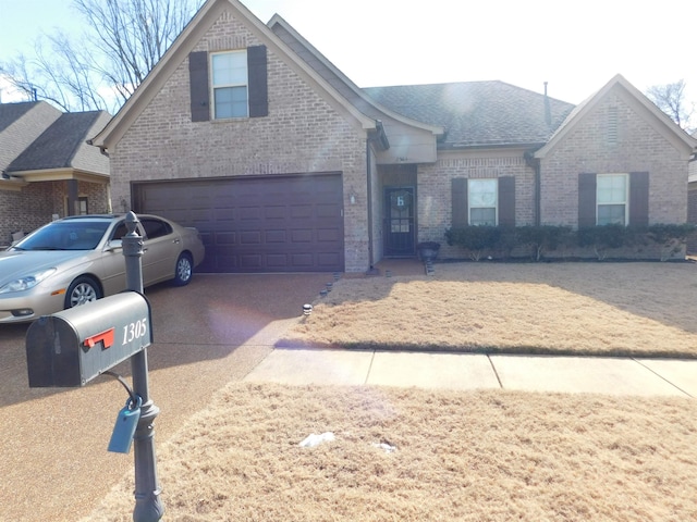 view of front of house featuring concrete driveway, an attached garage, brick siding, and roof with shingles