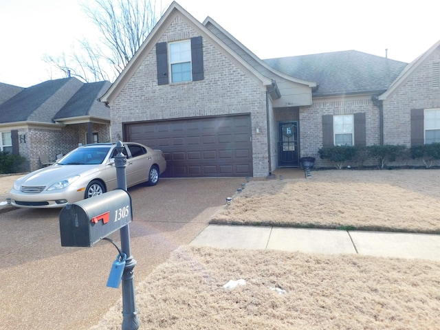 view of front of home featuring a garage, brick siding, driveway, and roof with shingles