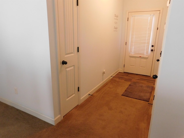 doorway with light carpet and baseboards