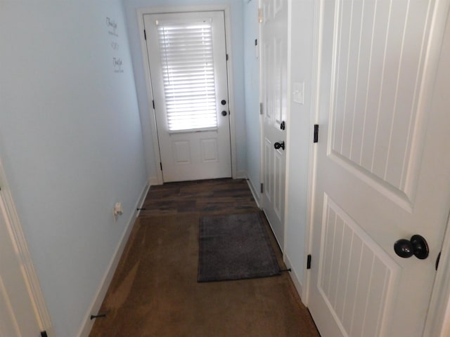 doorway to outside with baseboards