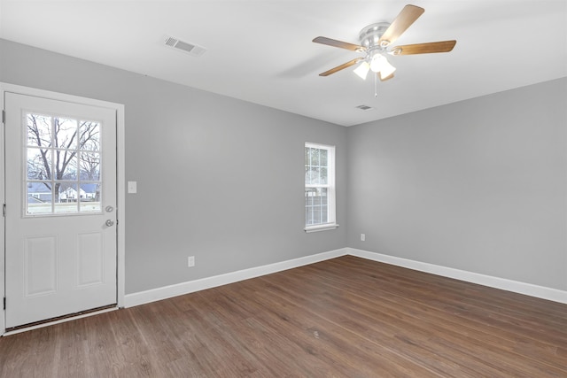 foyer entrance featuring ceiling fan and dark wood-type flooring