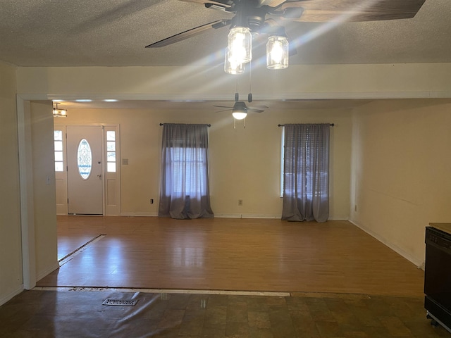 entrance foyer with ceiling fan, a textured ceiling, and hardwood / wood-style flooring