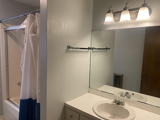 bathroom featuring shower / tub combo and vanity