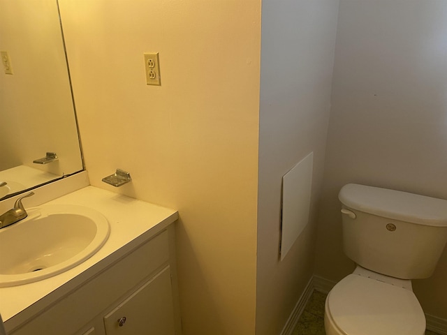 bathroom featuring toilet, vanity, and tile patterned flooring