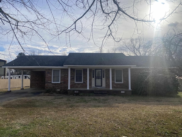 single story home featuring a front lawn, a carport, and covered porch